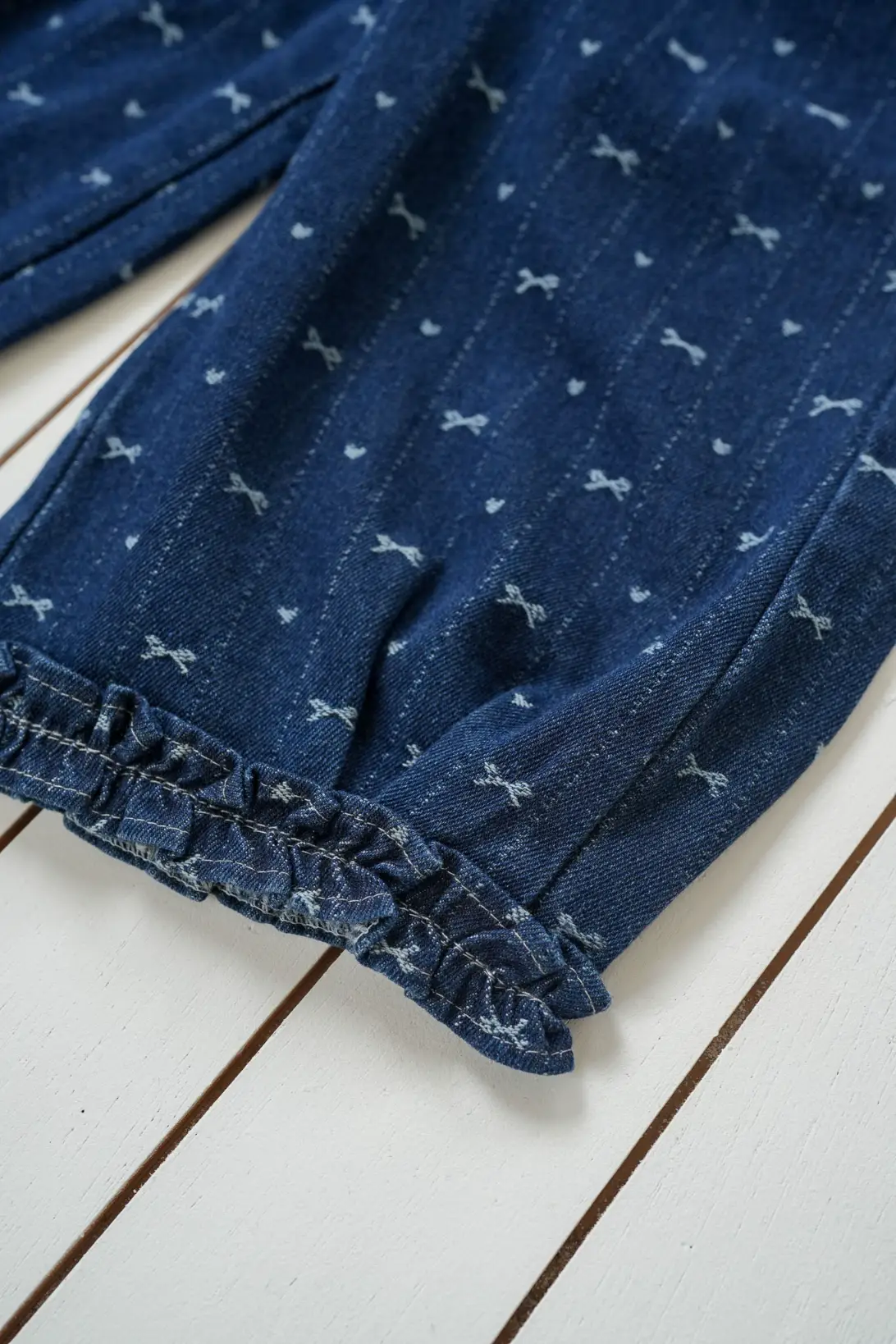 Bow Denim Jeans close-up with bow print and ruffled hem