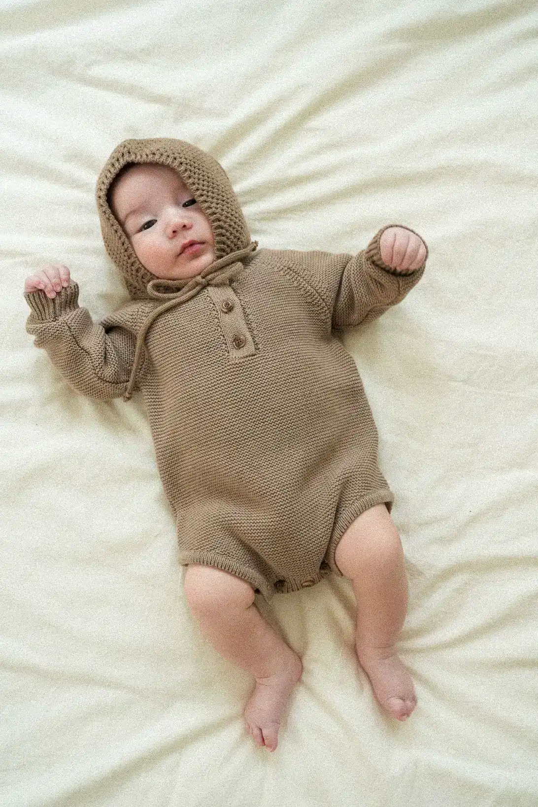 Little Nest 100% cotton knitted baby bodysuit in neutral colours – LULLA Soft textured knit detail of brown baby bonnet