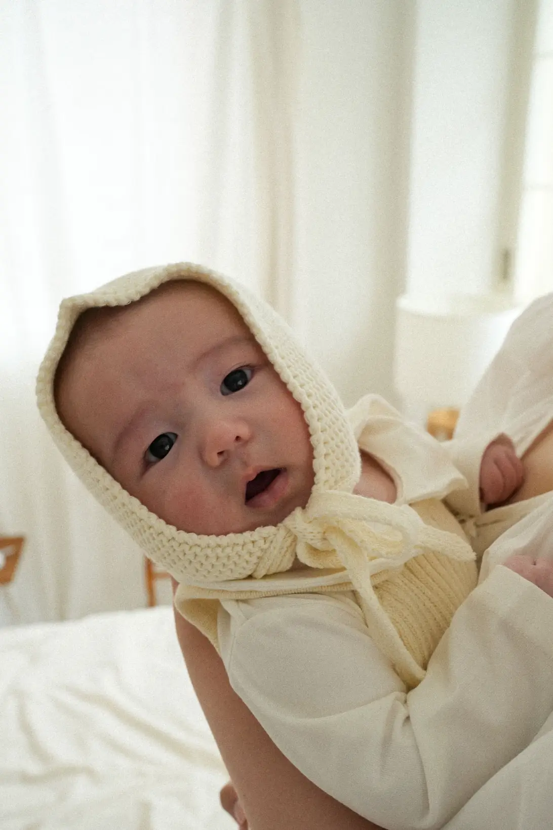 Baby wearing cream cotton Little Gnome Bonnet