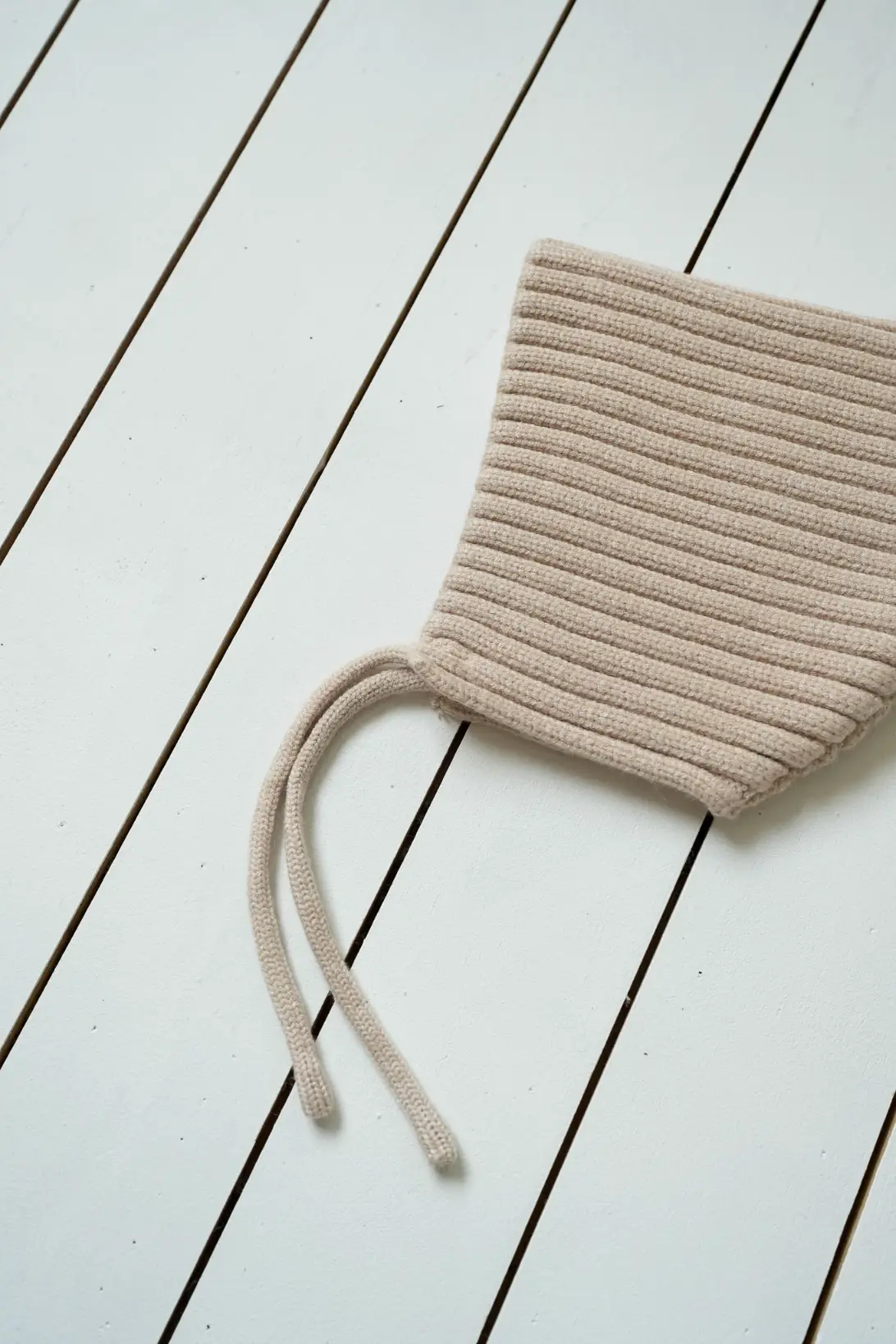 Beige baby pixie bonnet with tie straps