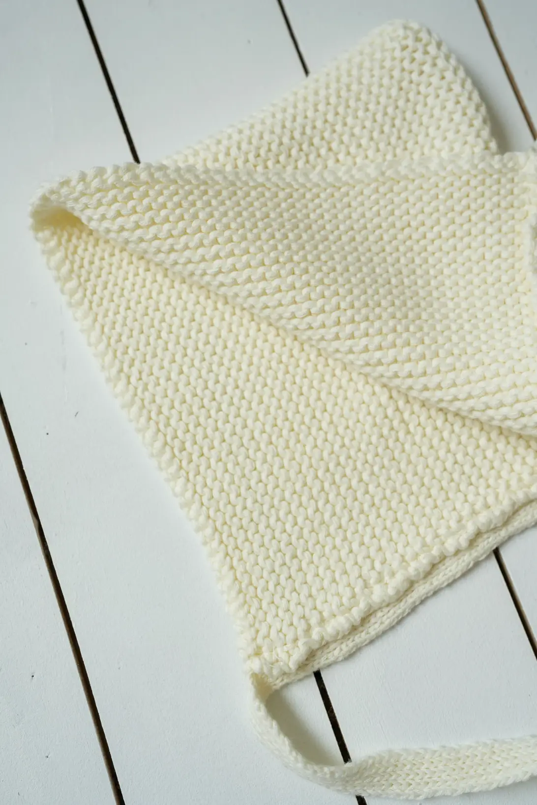 Baby wearing cream cotton Little Gnome Bonnet