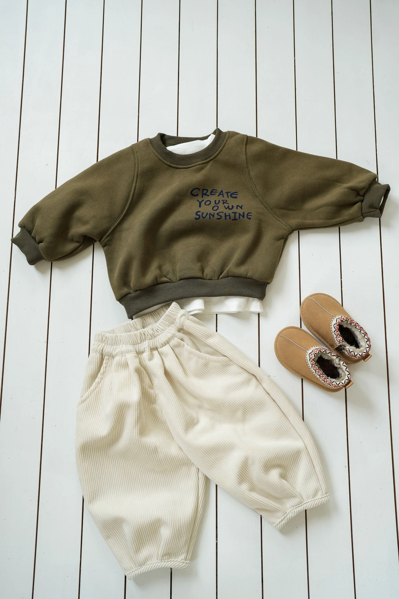 Cream corduroy kids pants with elasticated waist and relaxed fit