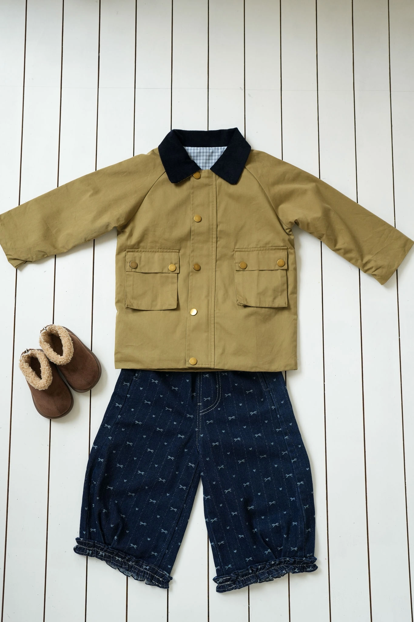 image: Bow Denim Jeans for girls with delicate bow print and ruffled cuffs with a trench coat